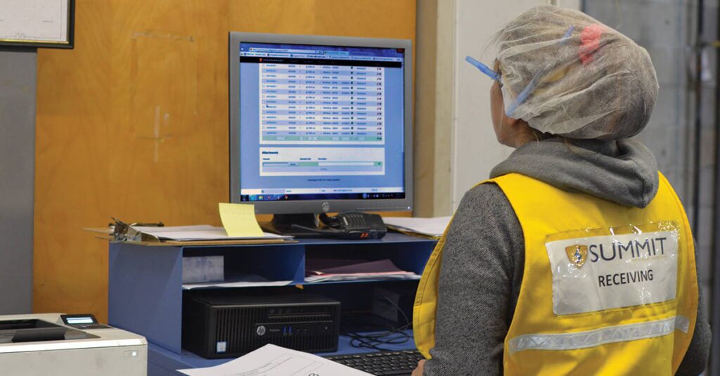 worker at Summit Container plant